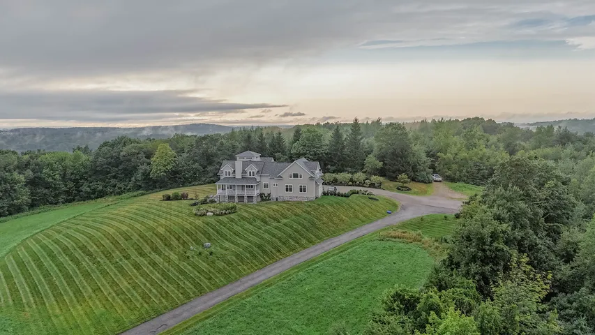 Aerial view of a country estate surrounded by fields and trees