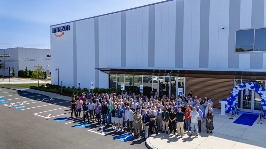 Team gathered outside a modern industrial building