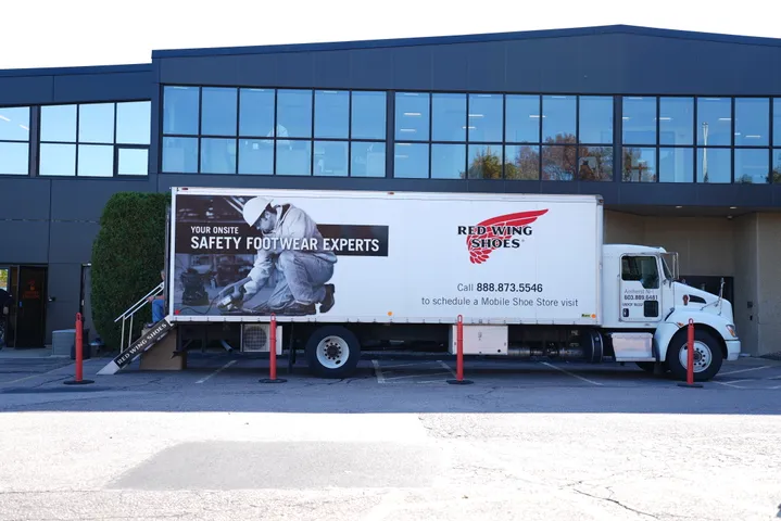 Branded service truck outside a commercial building