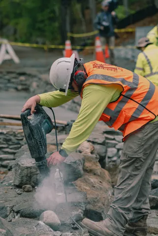 Construction worker cutting masonry outdoors
