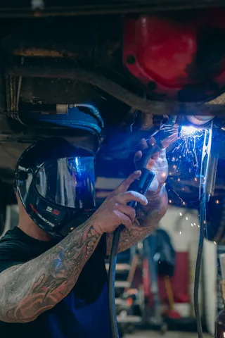Close-up of a welder wearing a protective helmet