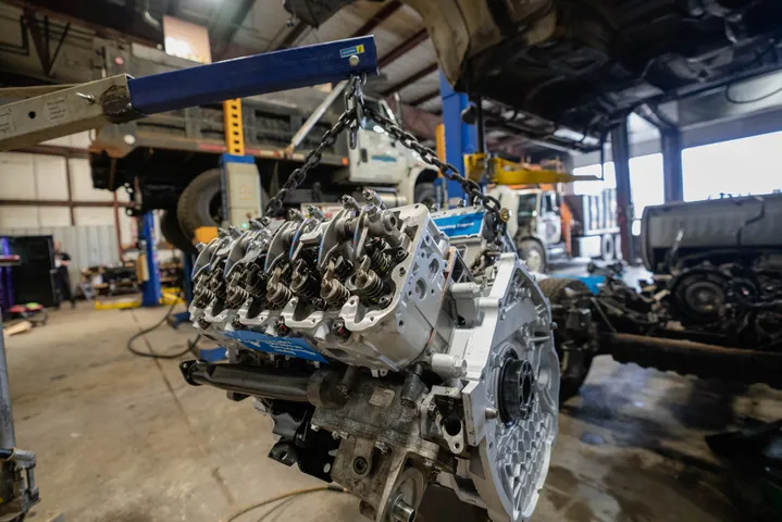 Vehicle engine being serviced in an automotive workshop