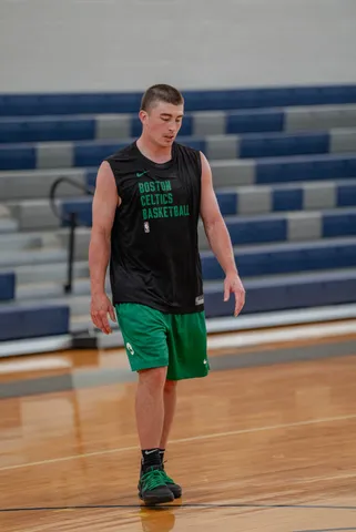Basketball player walking across an indoor court