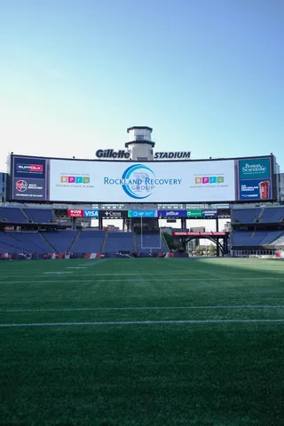 Football field beneath a stadium video board
