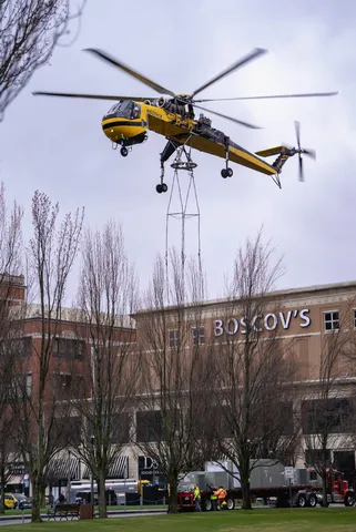 Helicopter lifting equipment near a city building