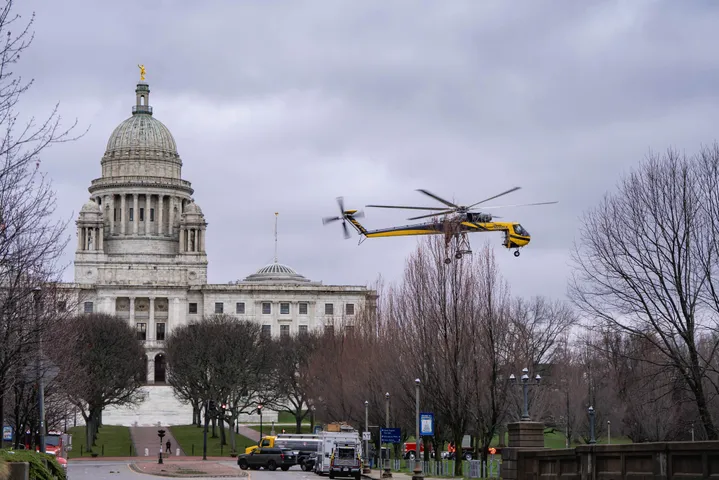 Helicopter beside a domed city landmark